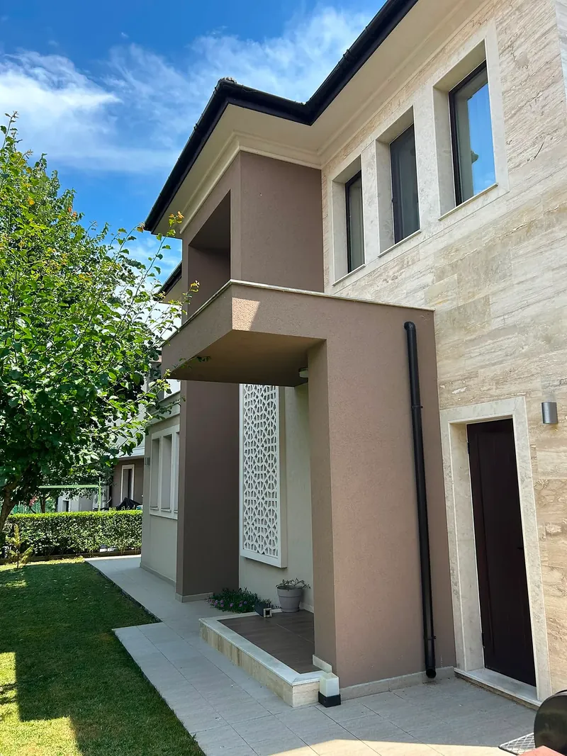Entrance side with front door and ornamental grille, villa in the Hill South quarter, Victoria development near Pomorie
