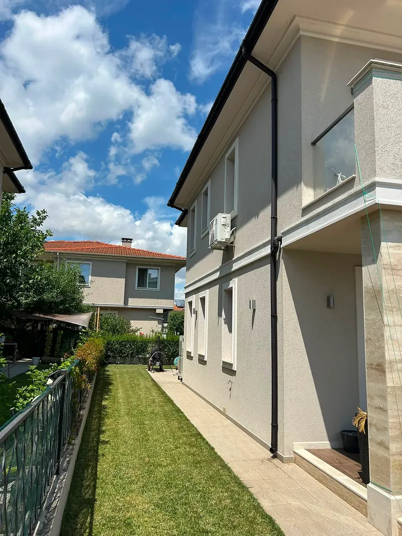 Side view with strip of lawn along the fence, villa in the Hill South quarter, Victoria development near Pomorie