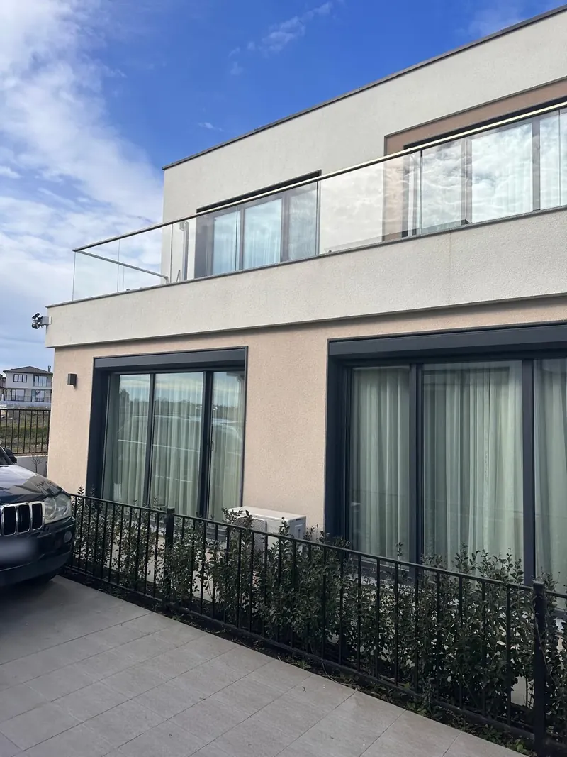 House front with fence and hedge, villa in the Summerset quarter, Victoria development near Pomorie
