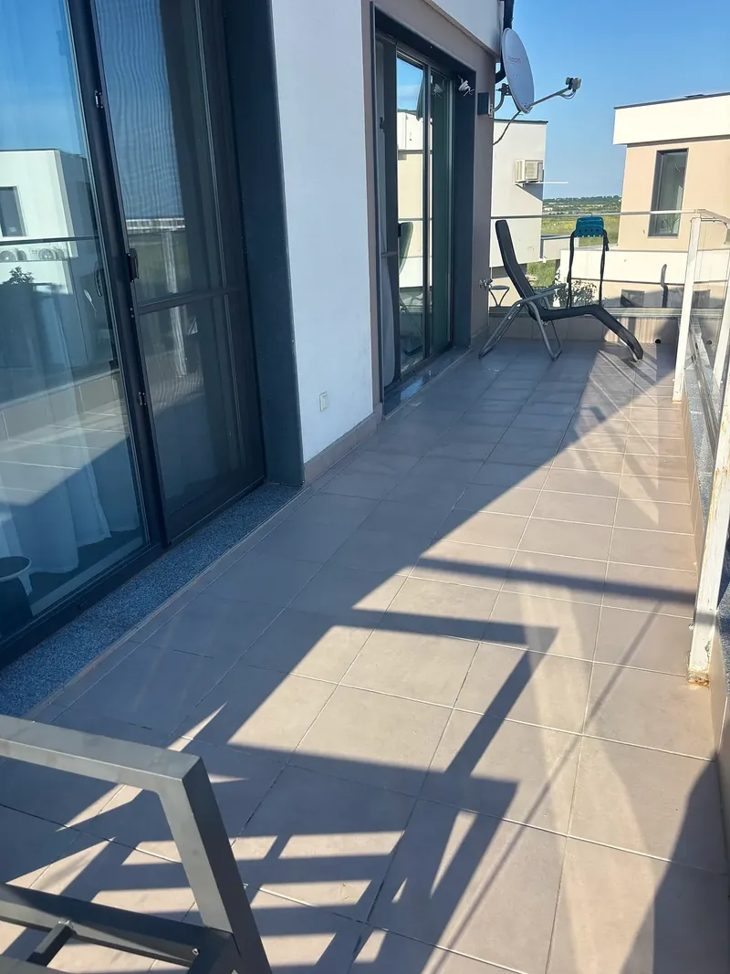 Upper-floor terrace with lounger and glass balustrade, villa in the Summerset quarter, Victoria development near Pomorie