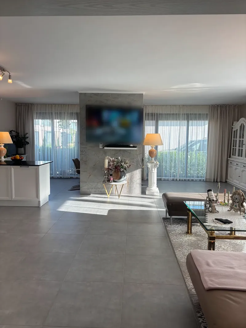 Open-plan living area with kitchen counter and seating area, villa in the Summerset quarter, Victoria development near Pomorie