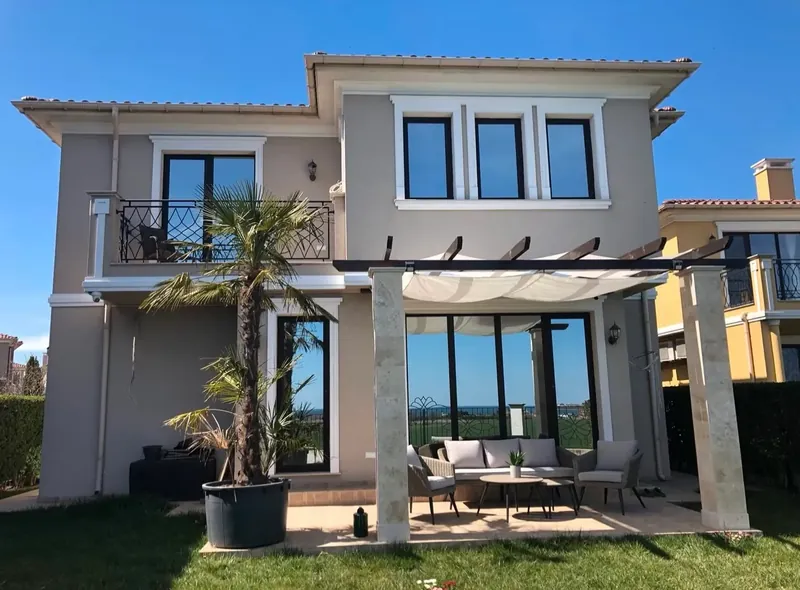 Garden side with pergola, palm tree and lounge furniture, villa in the Victoria Lakes quarter, Victoria development near Pomorie