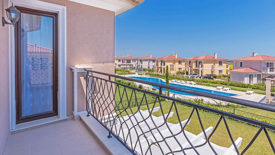 View from a balcony over the pool and villas