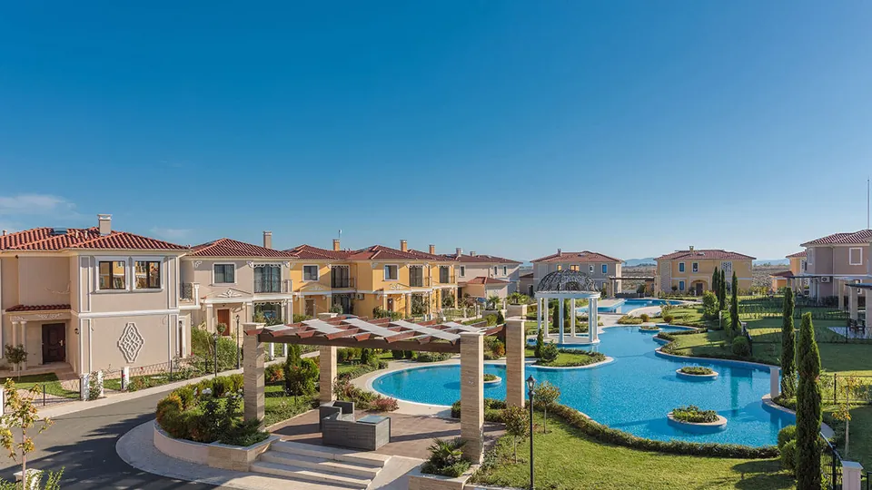 View across the pool area and the villas