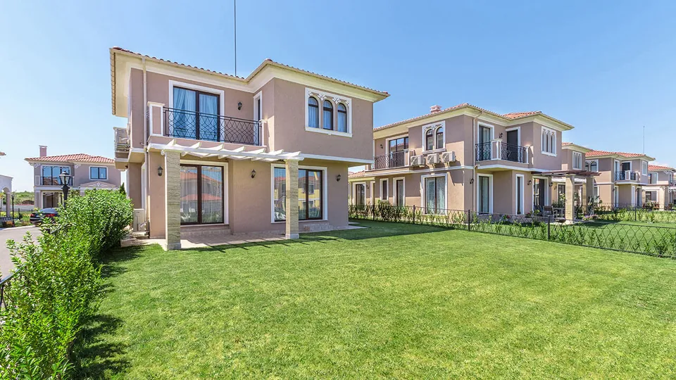 Villa with a pergola and a large lawn